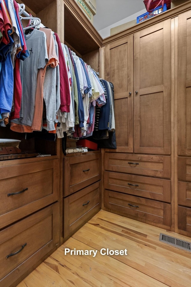 walk in closet featuring visible vents and wood finished floors