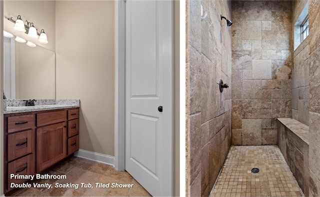 bathroom featuring a tile shower, vanity, and baseboards