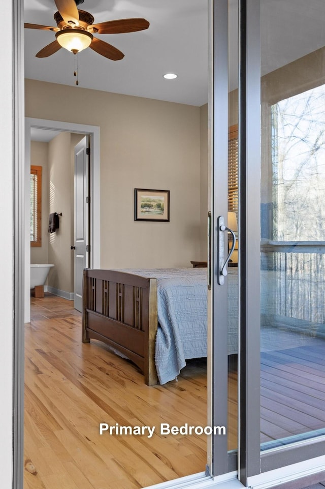 bedroom featuring baseboards and wood finished floors