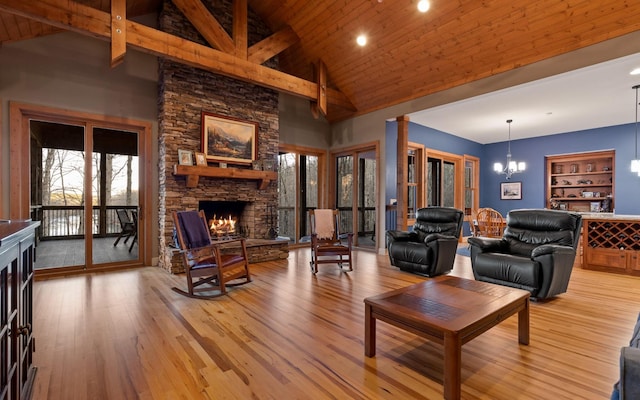 living area featuring a fireplace, high vaulted ceiling, light wood-style flooring, a chandelier, and wooden ceiling