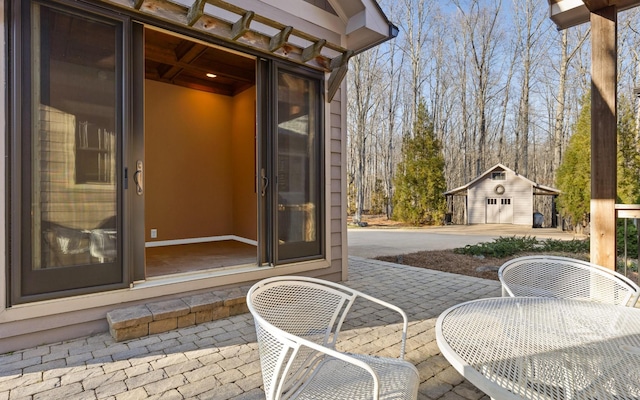 view of patio featuring an outbuilding