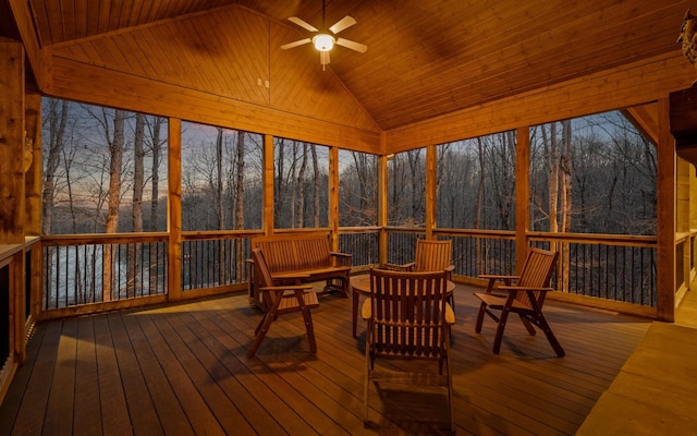 unfurnished sunroom with vaulted ceiling, wooden ceiling, and a ceiling fan