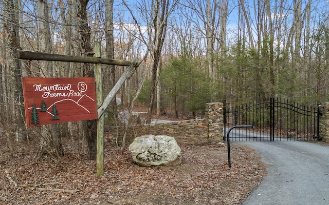 community sign featuring a gate