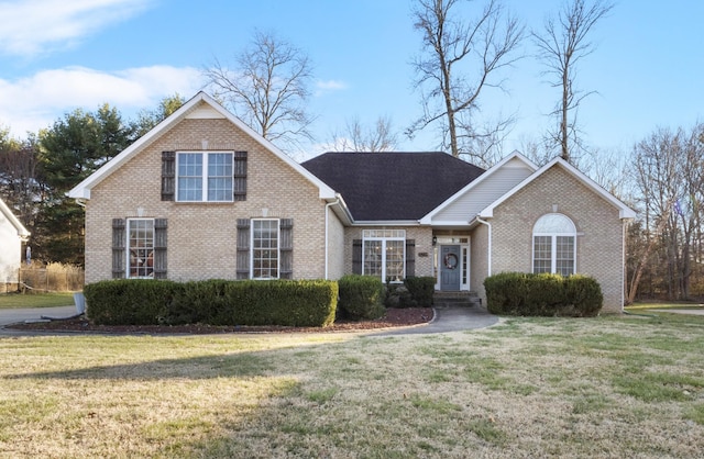 view of front of house featuring a front yard and brick siding