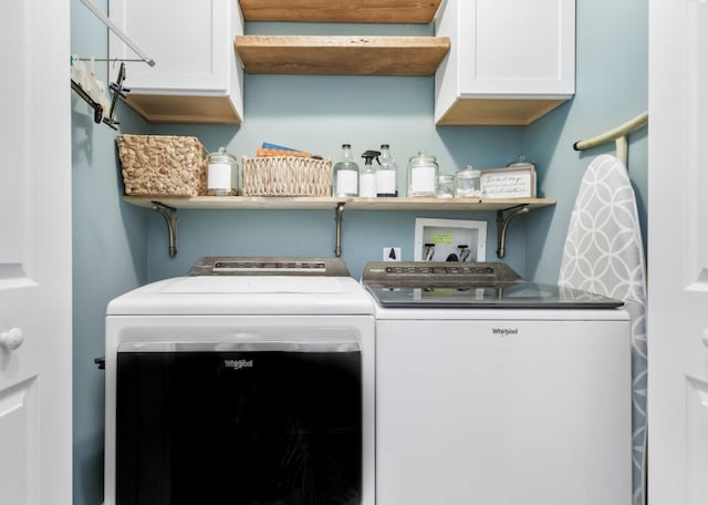 washroom with washer and dryer and cabinet space