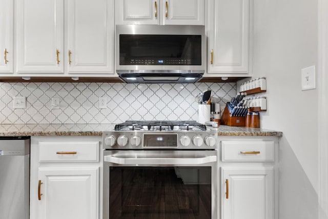 kitchen featuring appliances with stainless steel finishes, backsplash, and white cabinetry