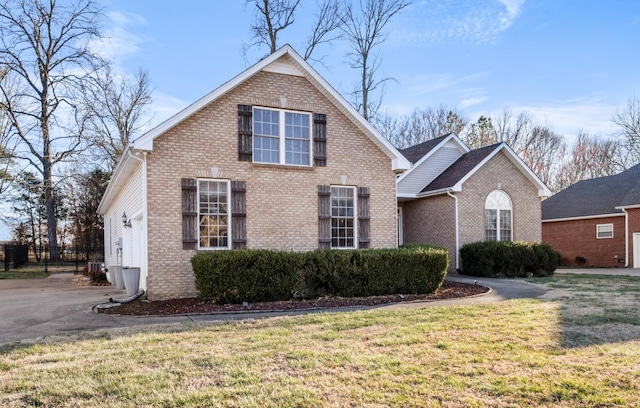 traditional-style house with a front lawn and brick siding