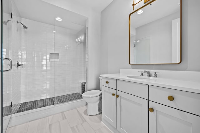 full bathroom featuring toilet, a shower stall, recessed lighting, and vanity