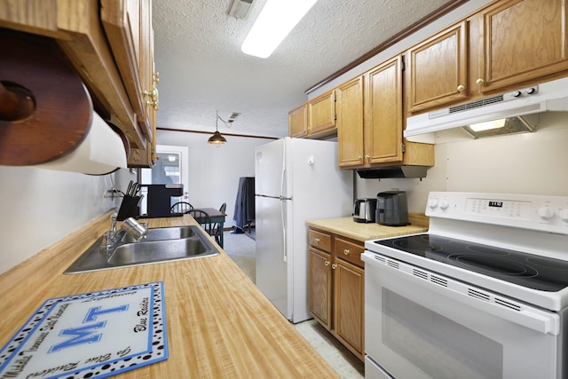 kitchen featuring white appliances, visible vents, a textured ceiling, under cabinet range hood, and a sink