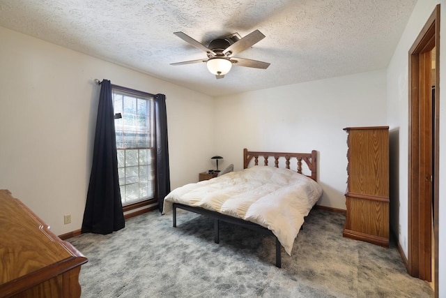 carpeted bedroom featuring ceiling fan, a textured ceiling, and baseboards