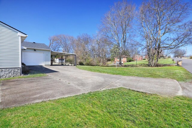 view of yard with concrete driveway