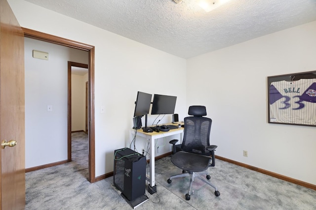 office featuring carpet floors, a textured ceiling, and baseboards