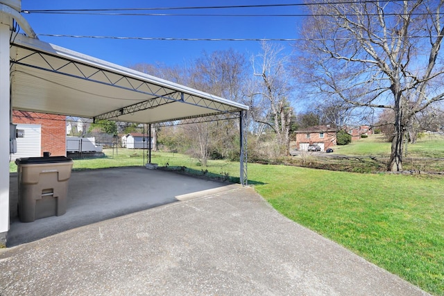 view of parking / parking lot featuring a carport, fence, and driveway