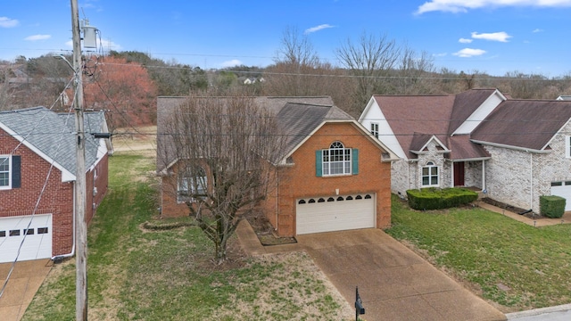 traditional-style house with concrete driveway, brick siding, an attached garage, and a front yard