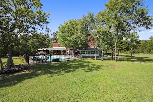 view of yard featuring a fenced in pool and a patio