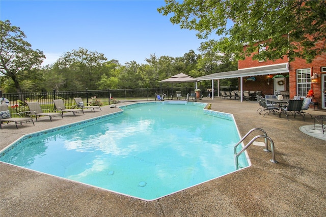 view of swimming pool with a patio, fence, and a fenced in pool