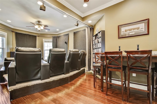 cinema featuring ornamental molding, wood finished floors, a ceiling fan, and recessed lighting