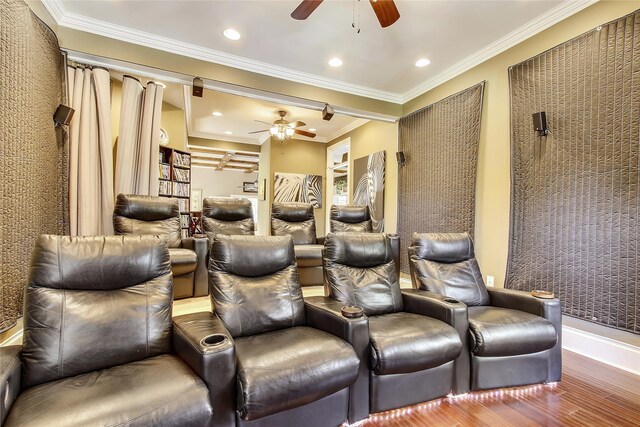 home theater with ornamental molding, recessed lighting, a ceiling fan, and wood finished floors