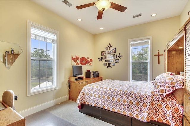 bedroom with visible vents, baseboards, and multiple windows