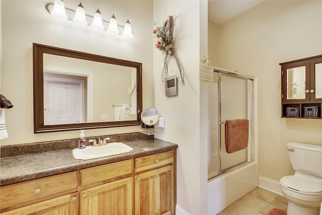 bathroom featuring enclosed tub / shower combo, tile patterned flooring, toilet, vanity, and baseboards