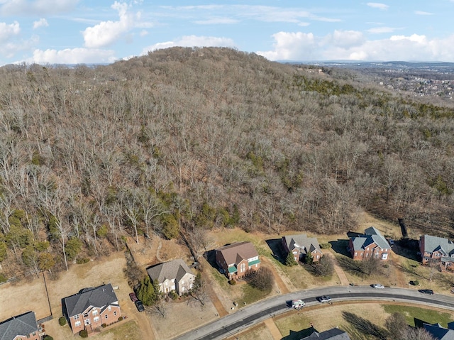 birds eye view of property featuring a forest view and a residential view