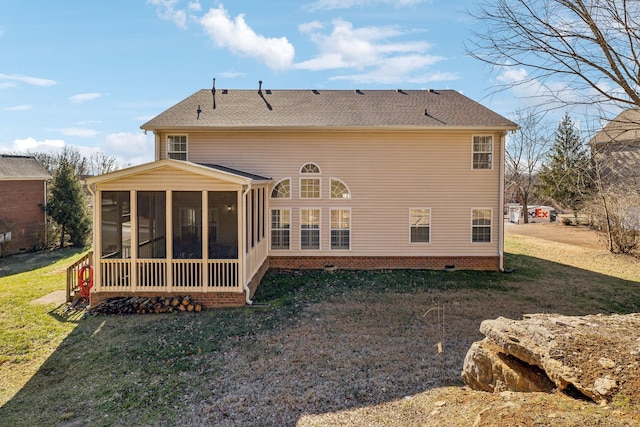 rear view of property with a sunroom, roof with shingles, and a yard