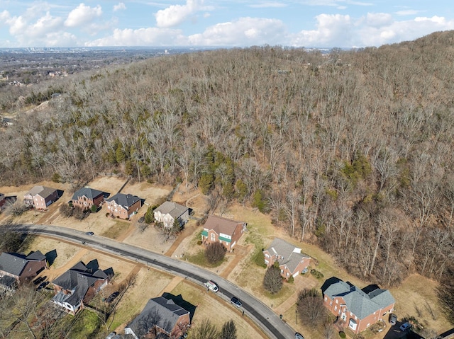 bird's eye view featuring a forest view and a residential view