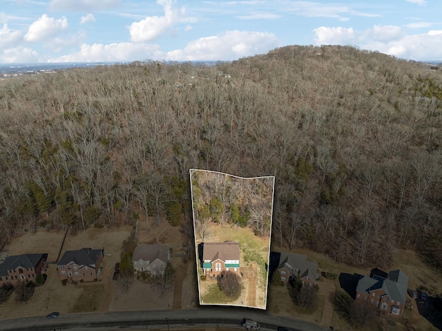 drone / aerial view featuring a forest view