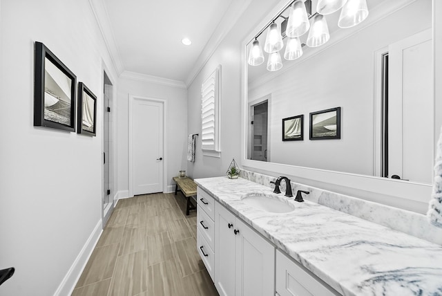 full bathroom with ornamental molding, a stall shower, vanity, and baseboards