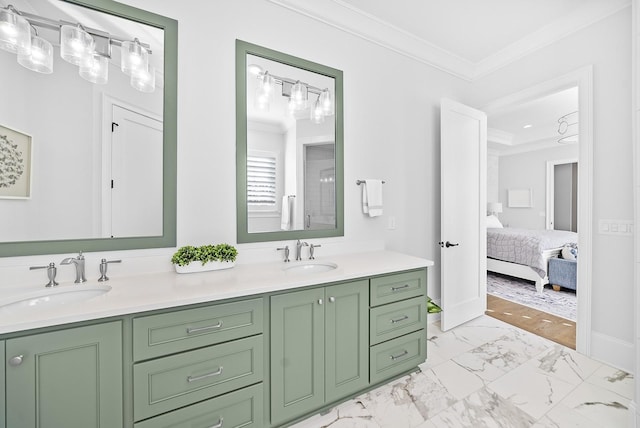 ensuite bathroom featuring double vanity, marble finish floor, ornamental molding, and a sink