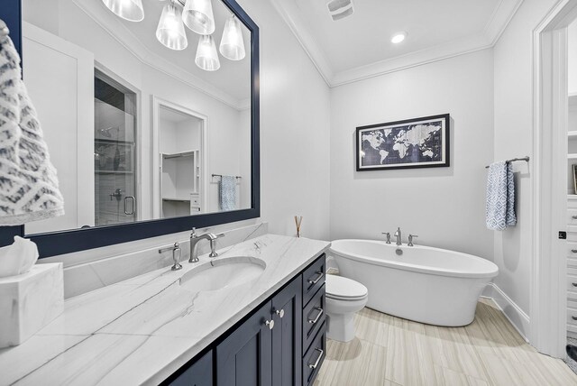 full bathroom featuring vanity, visible vents, a freestanding bath, ornamental molding, and a stall shower