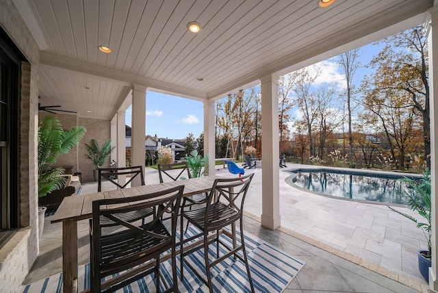 view of patio with outdoor dining area and an outdoor pool