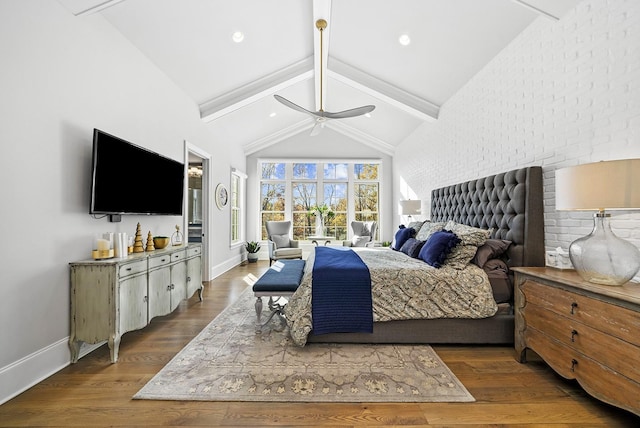 bedroom with lofted ceiling with beams, wood finished floors, a ceiling fan, and baseboards