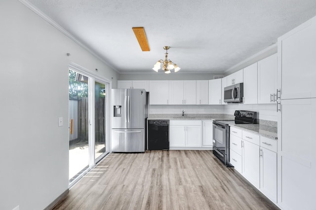 kitchen featuring light wood-type flooring, white cabinetry, crown molding, and black appliances