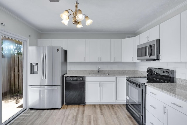 kitchen featuring a sink, white cabinets, ornamental molding, backsplash, and black appliances