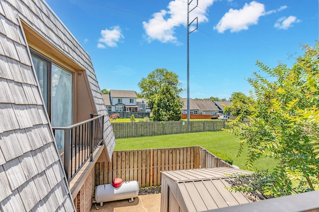 wooden deck featuring a lawn and fence