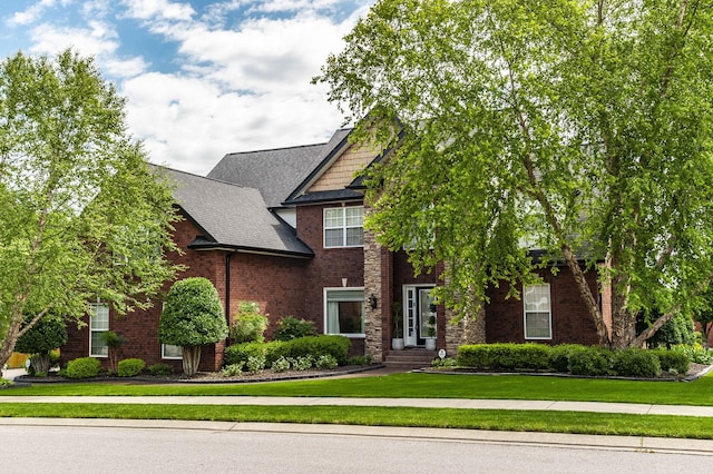 view of front of property with brick siding and a front lawn