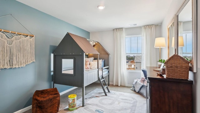 carpeted bedroom with baseboards and visible vents