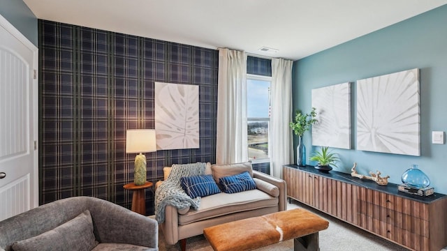 living area with carpet floors and visible vents