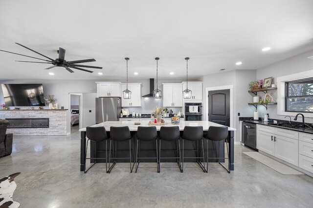 kitchen with wall chimney exhaust hood, freestanding refrigerator, finished concrete floors, open shelves, and a sink