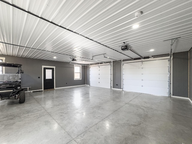 garage with metal wall and a garage door opener