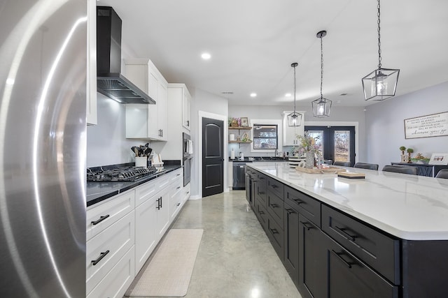 kitchen with open shelves, stainless steel appliances, a spacious island, white cabinets, and wall chimney exhaust hood