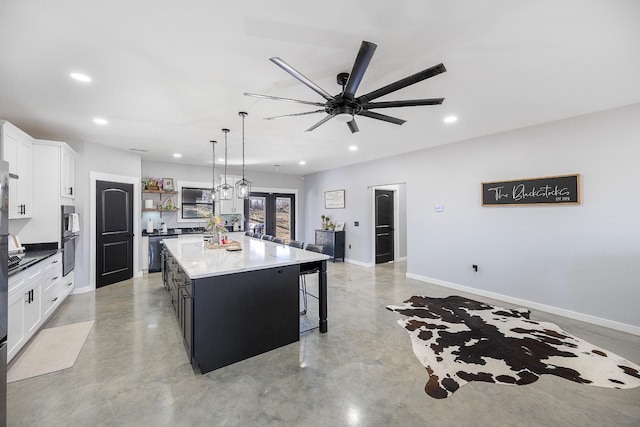 kitchen with recessed lighting, white cabinets, concrete floors, and open shelves