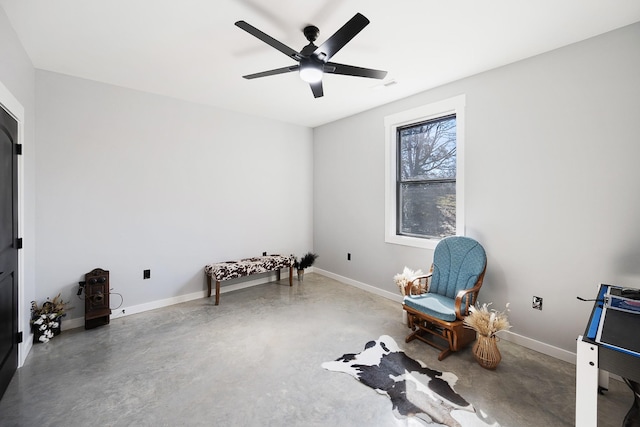 living area featuring visible vents, concrete floors, baseboards, and ceiling fan