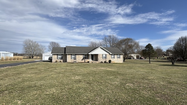 view of front of house with aphalt driveway and a front lawn