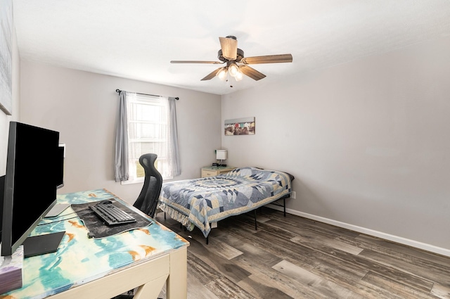 bedroom featuring a ceiling fan, baseboards, and wood finished floors