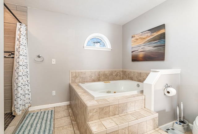 bathroom with baseboards, a bath, a tile shower, and tile patterned flooring