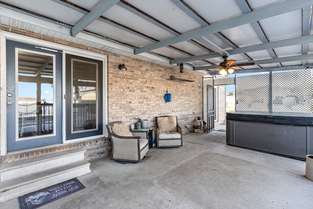 view of patio featuring a ceiling fan and a hot tub