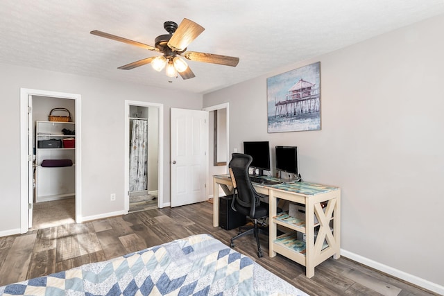 office space with a ceiling fan, wood finished floors, baseboards, and a textured ceiling