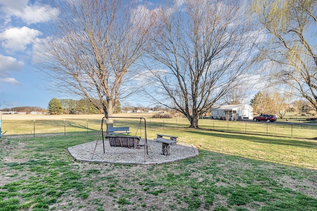 view of yard with an outdoor fire pit and fence